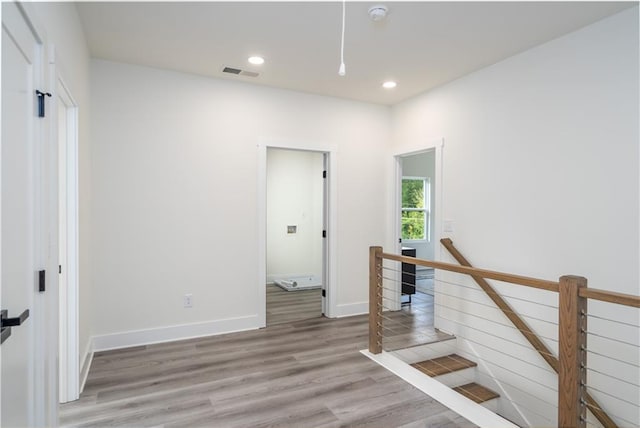 stairway with hardwood / wood-style flooring