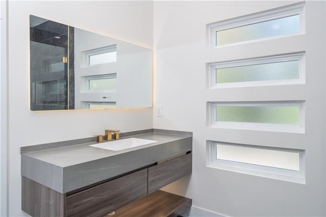 bathroom featuring walk in shower and vanity