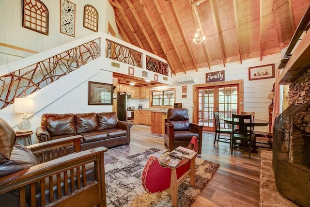 369 Trillium Rd, Suches, GA 30572 - living room with wood ceiling with exposed beams, wood finished floors, high vaulted ceiling, french doors, and wood walls