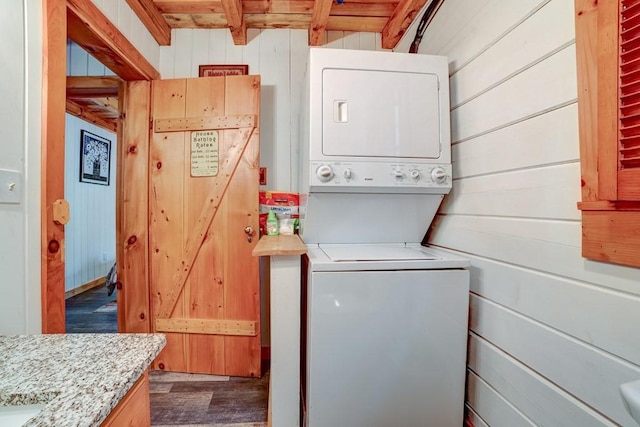 369 Trillium Rd, Suches, GA 30572 - laundry area featuring stacked washer / drying machine, dark wood-type flooring, and wooden walls