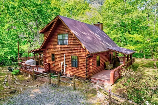 369 Trillium Rd, Suches, GA 30572 - view of side of home with a chimney, log siding, a deck, and a wooded view