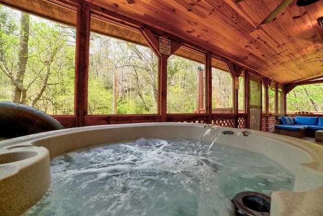 369 Trillium Rd, Suches, GA 30572 - sunroom with a jacuzzi, lofted ceiling, and a wooded view