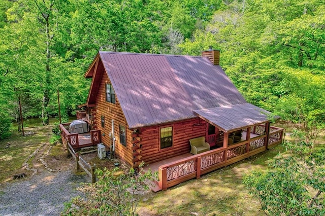 369 Trillium Rd, Suches, GA 30572 - rear view of house featuring log siding, a chimney, a wooden deck, and a forest view