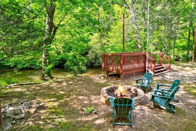 369 Trillium Rd, Suches, GA 30572 - view of yard featuring an outdoor fire pit, a wooden deck, and a view of trees