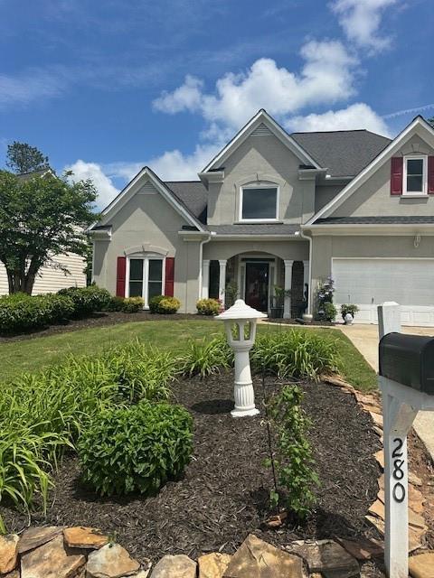 280 Ridge Bluff Ln, Suwanee, GA 30024 - view of front of property featuring stucco siding, concrete driveway, and a garage