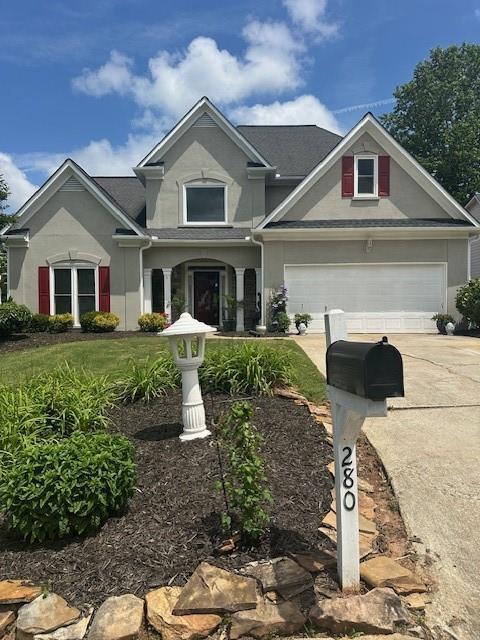 280 Ridge Bluff Ln, Suwanee, GA 30024 - view of front of property featuring driveway and stucco siding