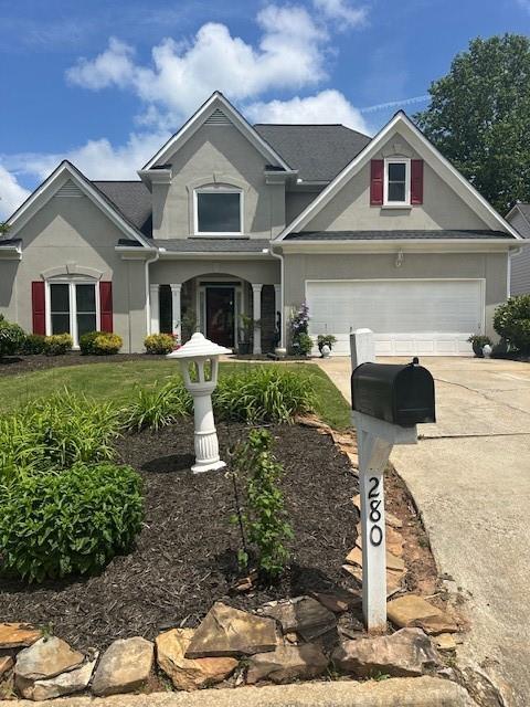 280 Ridge Bluff Ln, Suwanee, GA 30024 - view of front of home featuring driveway and stucco siding