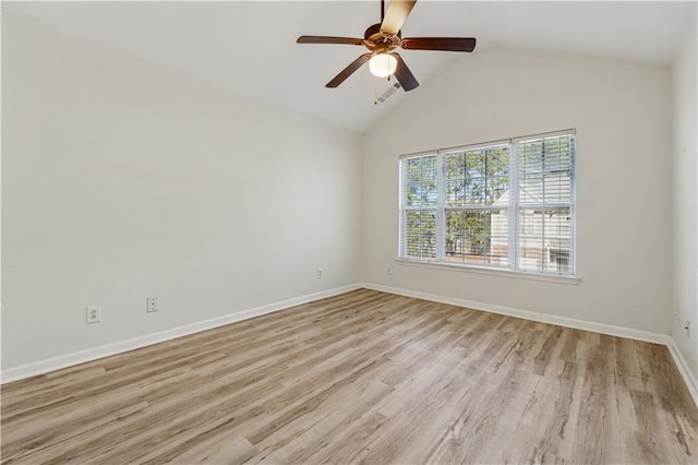 empty room featuring ceiling fan, lofted ceiling, and light wood-type flooring