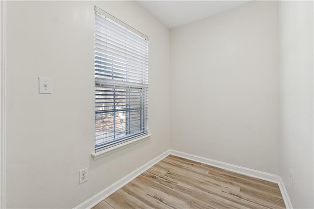 spare room featuring a wealth of natural light and light wood-type flooring