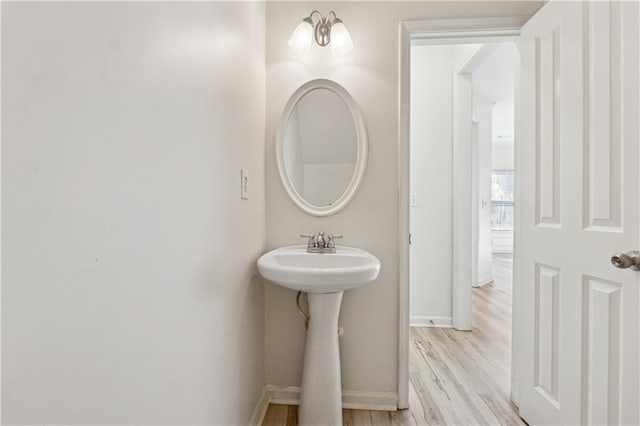 bathroom featuring wood-type flooring and sink