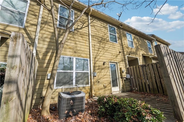 rear view of property featuring central AC