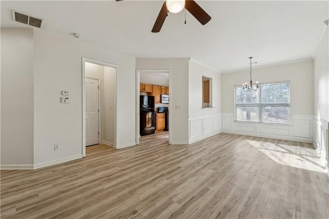 unfurnished living room with crown molding, ceiling fan with notable chandelier, and light hardwood / wood-style flooring