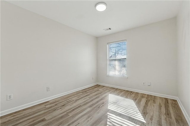 spare room with light wood-type flooring