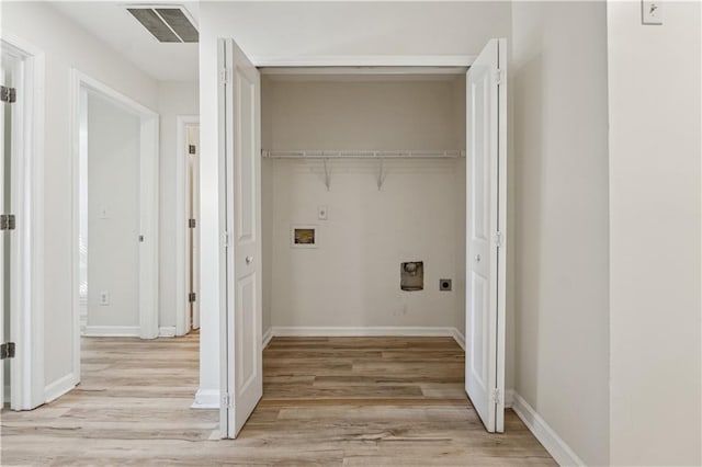 washroom with light hardwood / wood-style floors, hookup for a washing machine, and electric dryer hookup