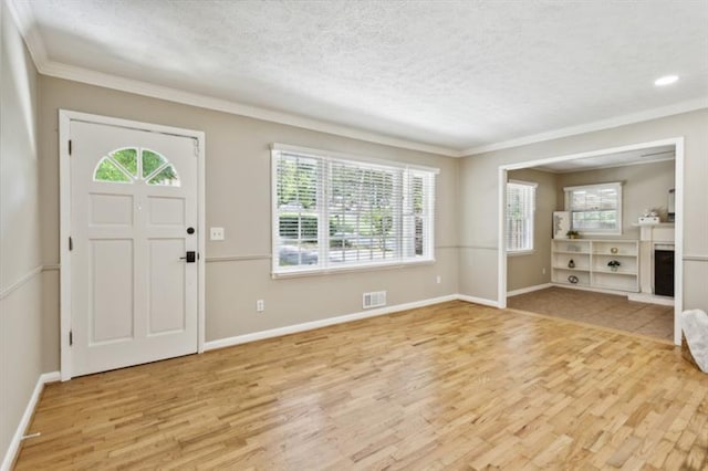 entryway featuring light wood-type flooring and crown molding