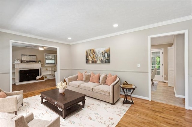 living room with ornamental molding and hardwood / wood-style floors