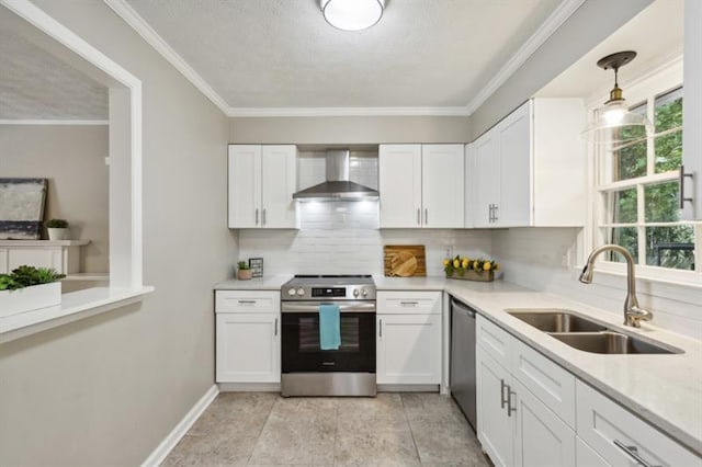 kitchen featuring stainless steel appliances, sink, decorative light fixtures, white cabinetry, and wall chimney exhaust hood