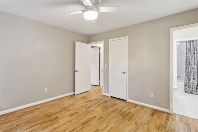 unfurnished bedroom featuring light wood-type flooring, ceiling fan, and connected bathroom