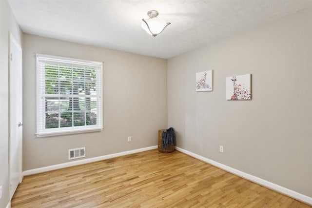 unfurnished room with light wood-type flooring