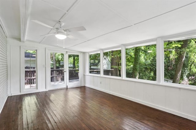 unfurnished sunroom featuring ceiling fan and plenty of natural light