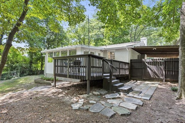 rear view of property featuring a deck