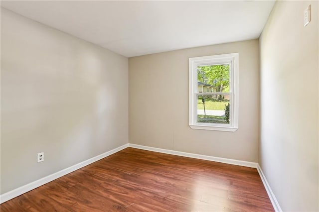 empty room with wood finished floors and baseboards