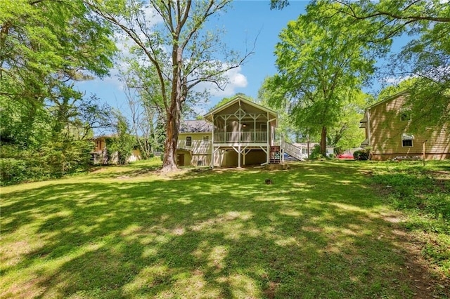 view of yard with a sunroom and stairs