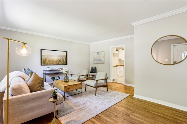 living area with light wood-style floors, baseboards, and ornamental molding