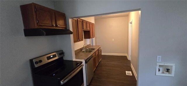 kitchen featuring appliances with stainless steel finishes, dark hardwood / wood-style flooring, ventilation hood, and sink