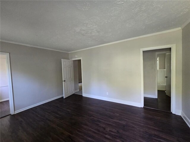 empty room with dark hardwood / wood-style floors, crown molding, and a textured ceiling