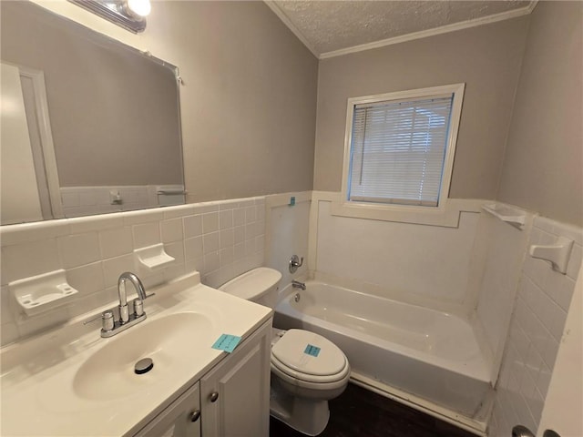 full bath featuring vanity, wainscoting, a textured ceiling, toilet, and a washtub