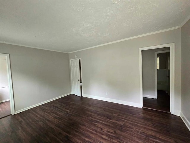 unfurnished room with baseboards, a textured ceiling, dark wood finished floors, and ornamental molding