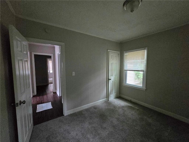 unfurnished bedroom featuring baseboards and carpet flooring