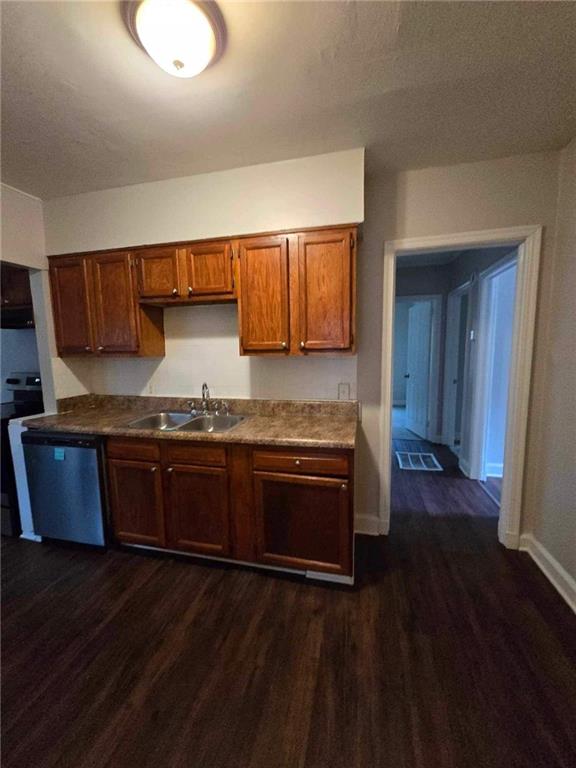 kitchen with dishwasher, sink, and dark hardwood / wood-style floors