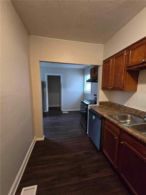 kitchen with dark countertops, dishwasher, electric range oven, dark wood-style flooring, and a sink