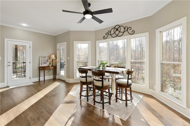 sunroom / solarium featuring ceiling fan