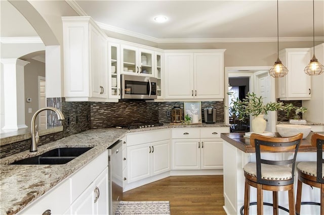 kitchen with sink, decorative light fixtures, white cabinets, and appliances with stainless steel finishes