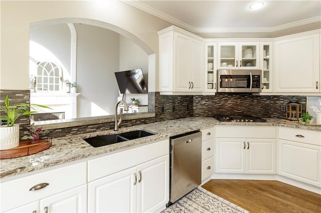 kitchen featuring light stone counters, stainless steel appliances, sink, and white cabinets