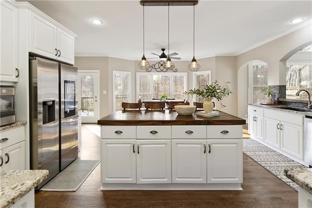 kitchen with sink, white cabinetry, stainless steel appliances, dark hardwood / wood-style floors, and wood counters