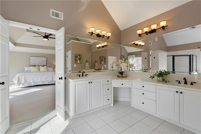 bathroom with ceiling fan, vanity, tile patterned flooring, and vaulted ceiling