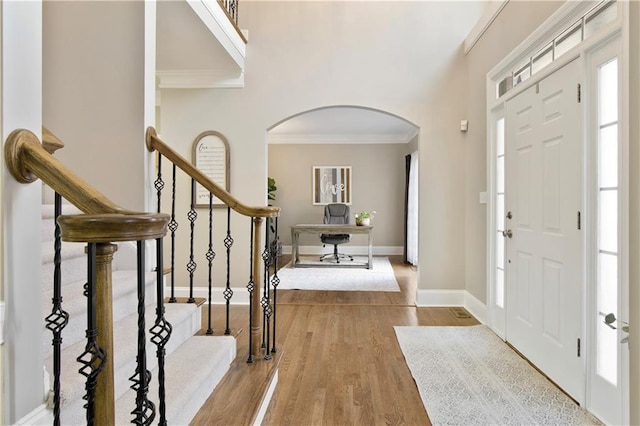 foyer with hardwood / wood-style floors and ornamental molding