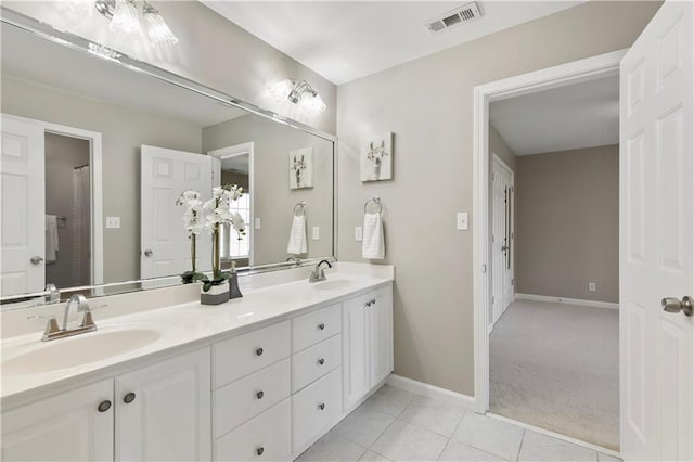 bathroom with tile patterned floors and vanity