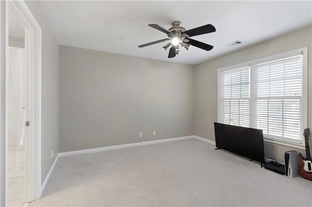 carpeted empty room featuring ceiling fan