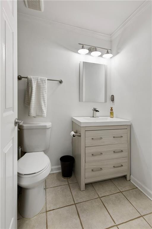 bathroom with vanity, tile patterned floors, ornamental molding, and toilet