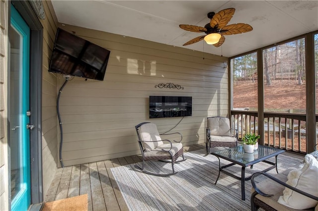 sunroom featuring ceiling fan