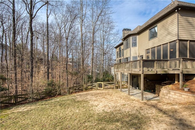 view of yard with a deck and a sunroom