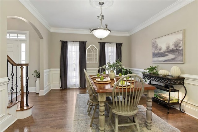 dining space featuring crown molding and dark hardwood / wood-style floors