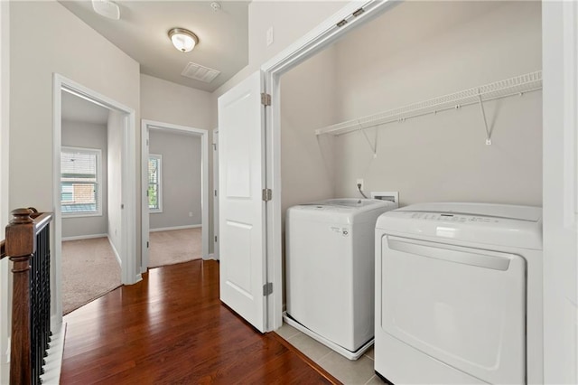 washroom with washer and dryer and hardwood / wood-style floors