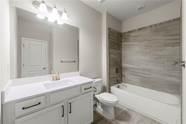 full bathroom featuring vanity, toilet, and tiled shower / bath