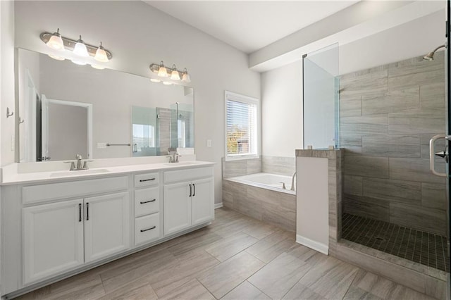 bathroom featuring vanity and separate shower and tub